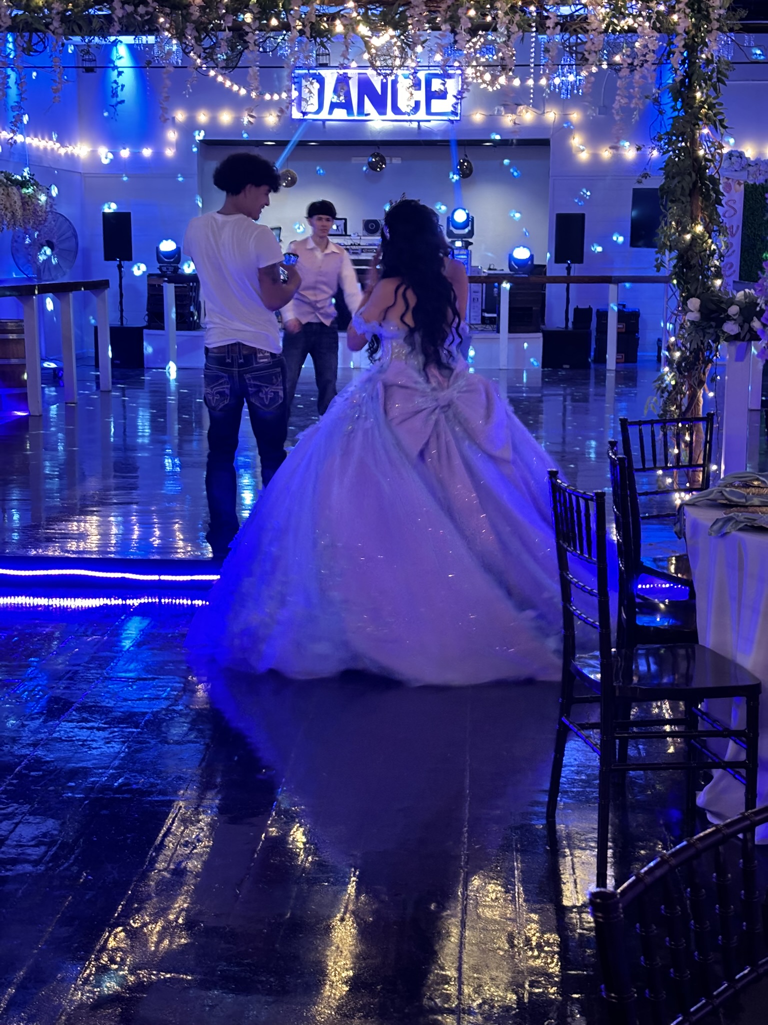 Quinceanera girl and court view the dance floor for the first time.