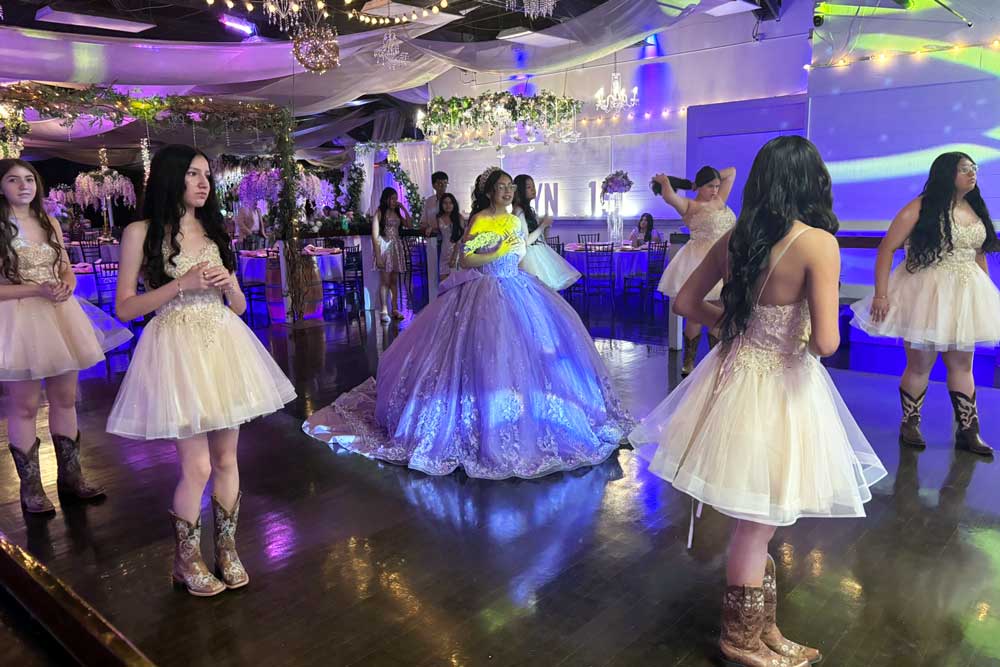 Quinceanera court dancing with the quince girl in the center.