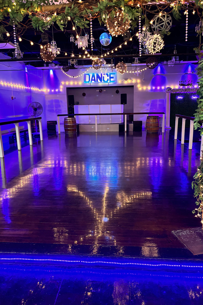 Dance floor with string lights and ambient lighting creating a warm atmosphere
