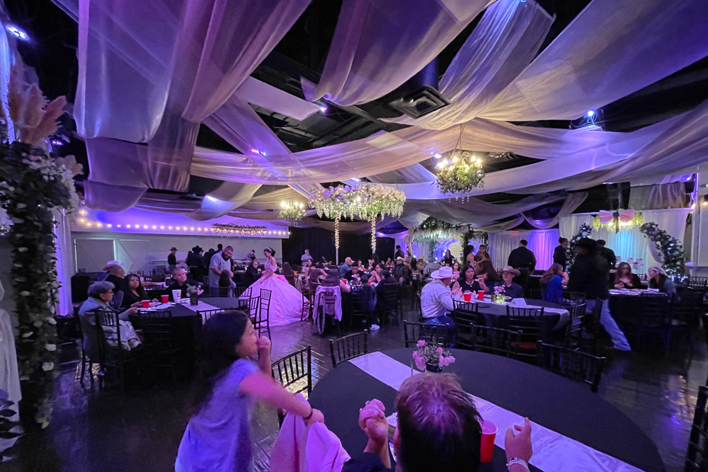 Elegant ceiling draping with soft fabric and lighting across reception space