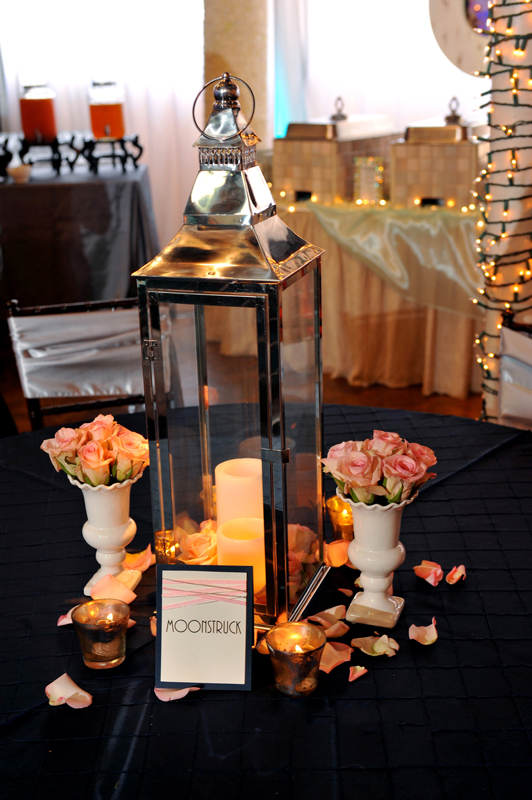 Lantern centerpiece with soft lighting and greenery for wedding or event tables at The Chateau at Forest Park