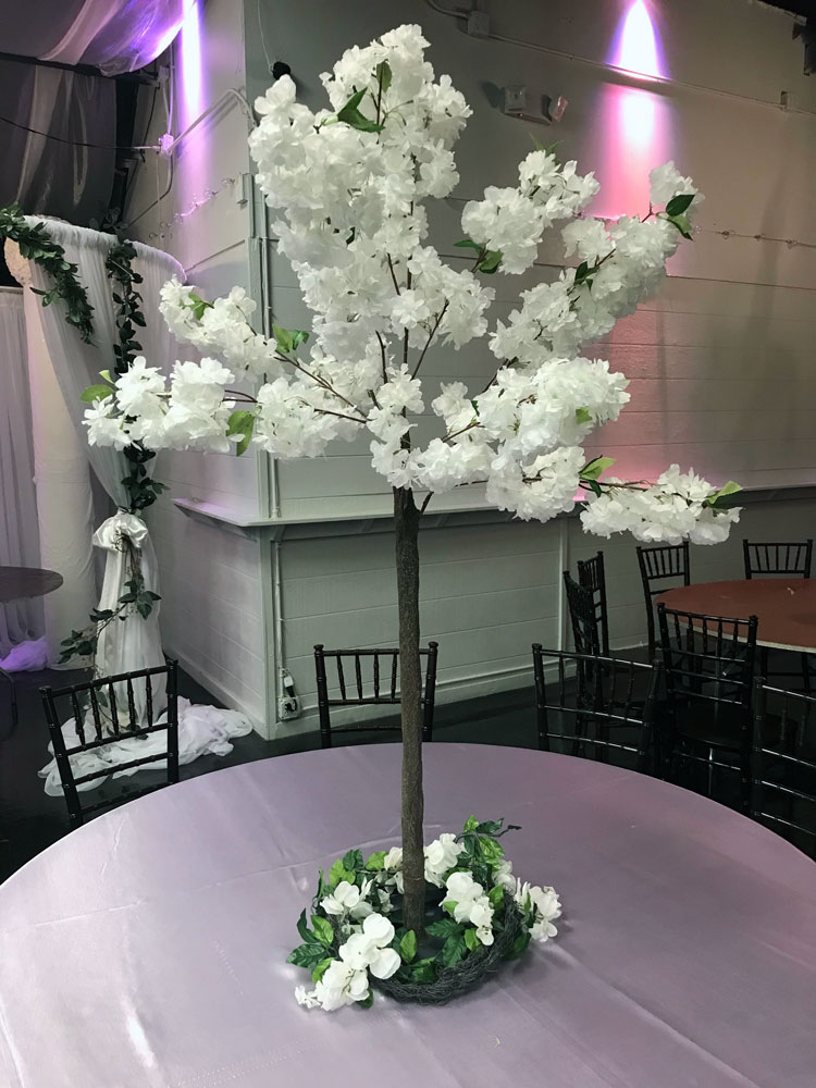 Tall luxury statement centerpiece with florals and greenery for a dramatic event table display at The Chateau at Forest Park