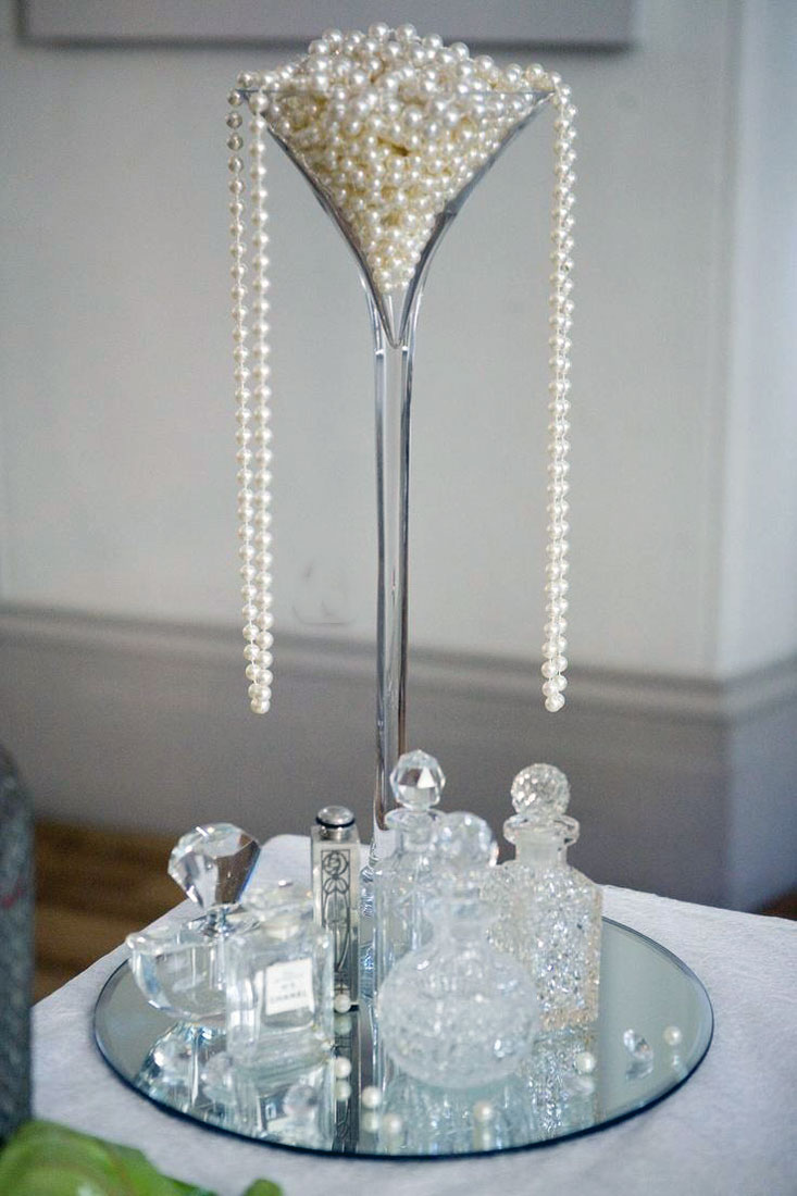 Modern long stemmed martini glass centerpiece with pearls and lighting accents for an elegant event table at The Chateau at Forest Park