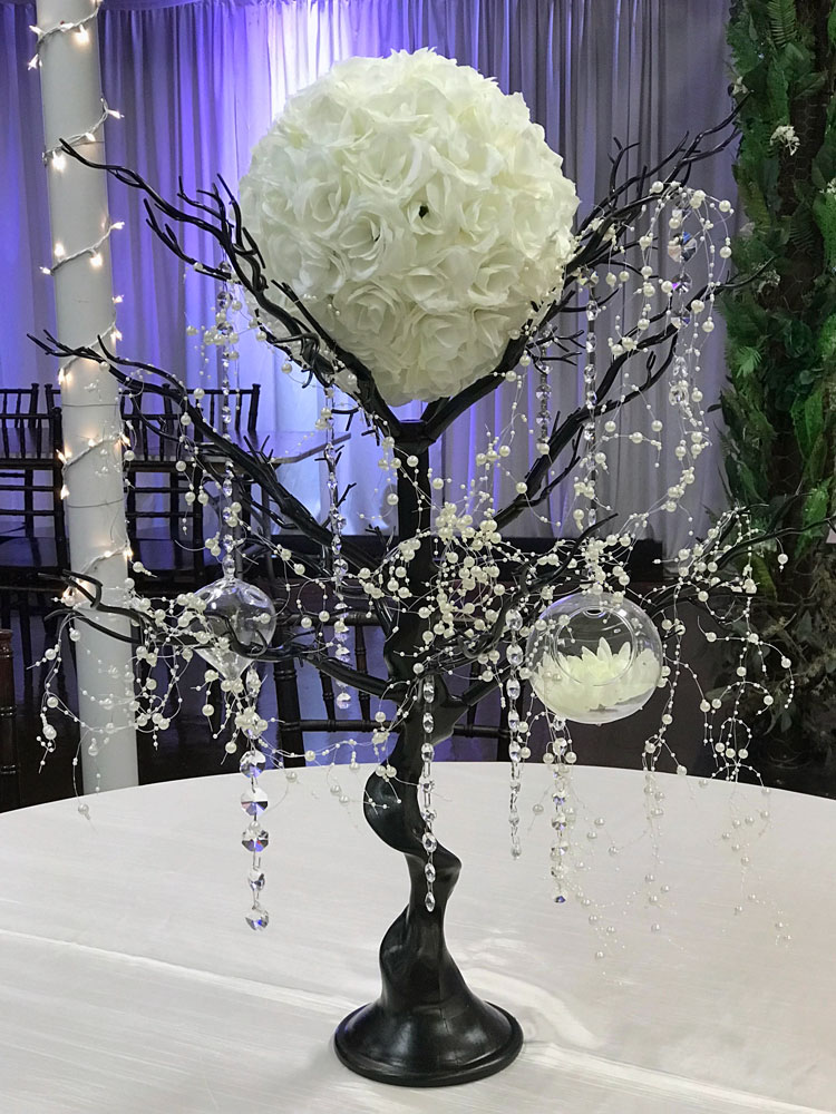 Rustic black branch centerpiece with natural wood elements, hanging jewels and a flower ball at The Chateau at Forest Park