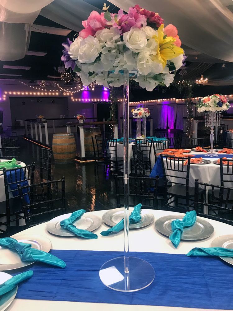 Tall statement centerpiece with florals and greenery for a dramatic event table display at The Chateau at Forest Park