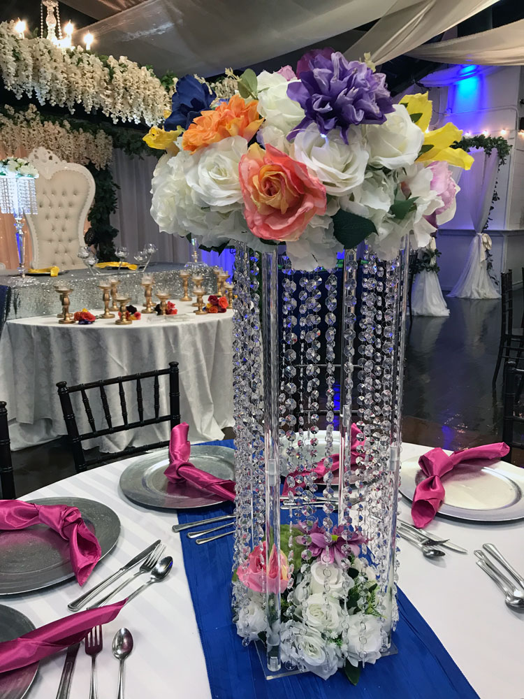 Tall statement centerpiece with jewels and florals for a dramatic event table display at The Chateau at Forest Park