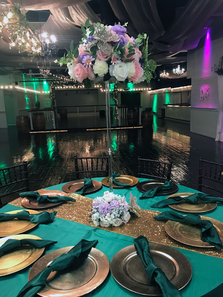 Tall statement centerpiece with greenery for a dramatic event table display at The Chateau at Forest Park