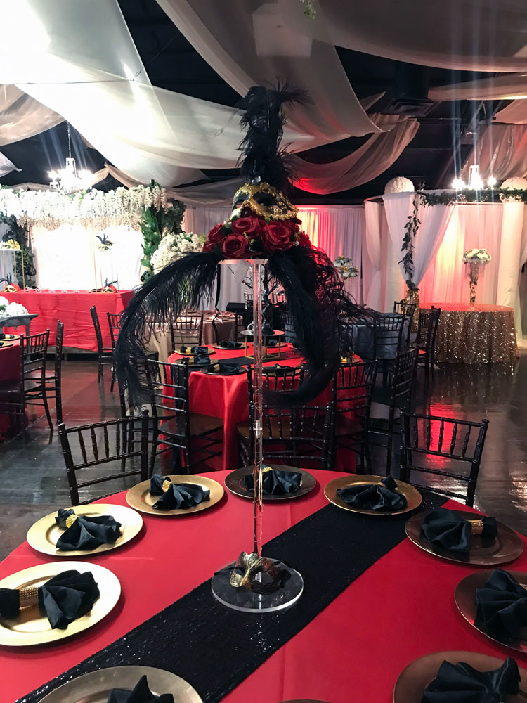 Tall statement centerpiece with ostrich feathers and floral for a dramatic event table display at The Chateau at Forest Park