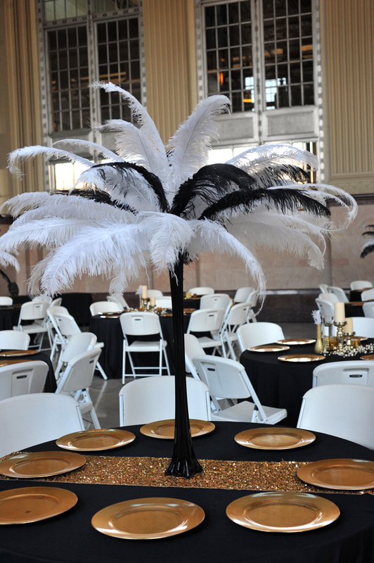 Tall glack glass centerpiece with ostrich feathers for a dramatic event table display at The Chateau at Forest Park