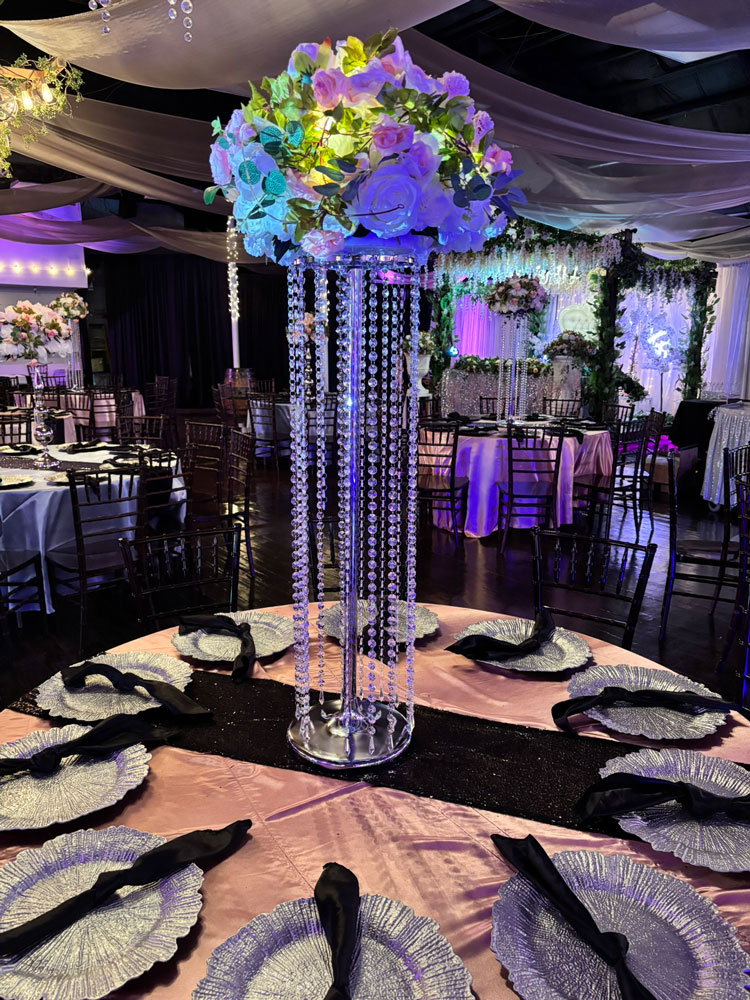 Hanging jewels frame centerpiece with flowers, greenery and more at the Chateau event venue