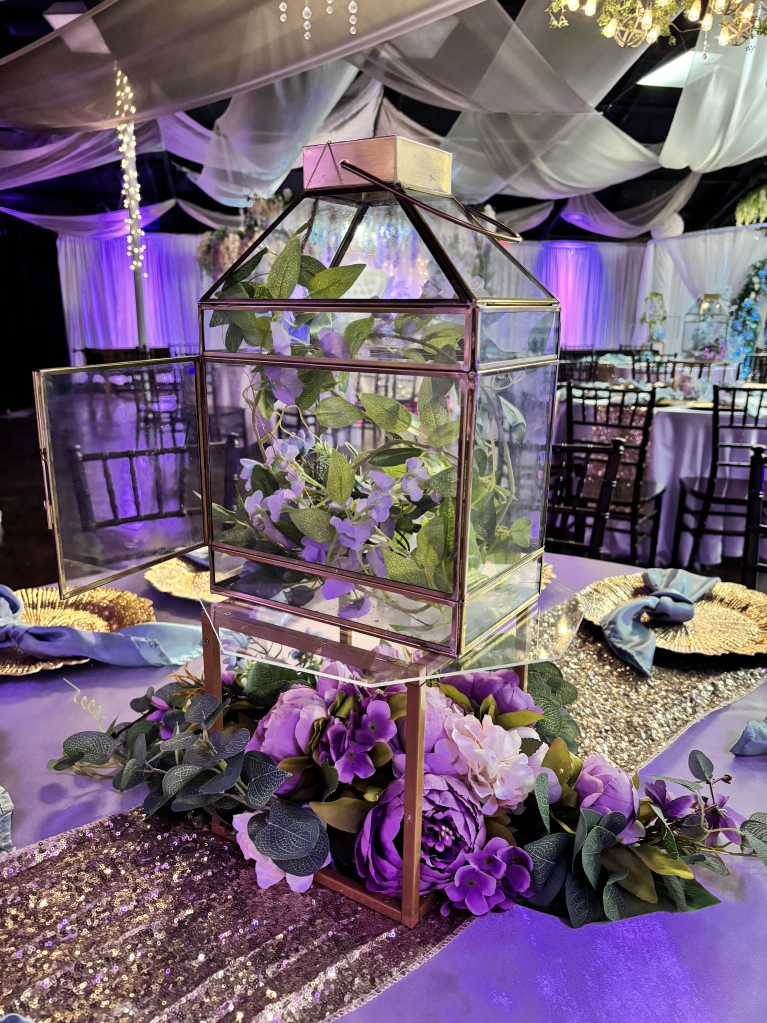 Gold framed centerpiece with flowers and greenery at The Chateau at Forest Park