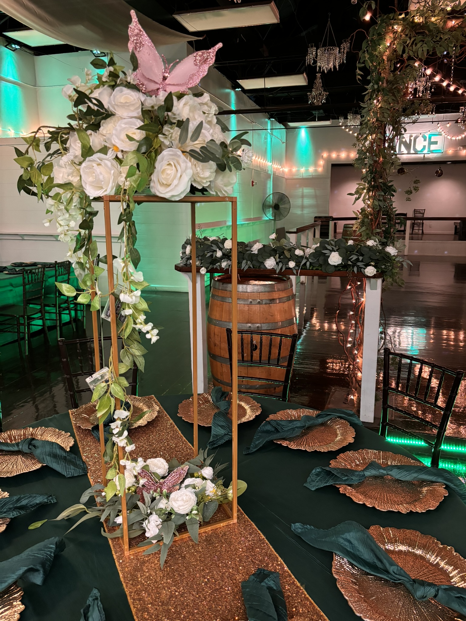 Tall Gold wire statement centerpiece with florals and greenery for a dramatic event table display at The Chateau at Forest Park