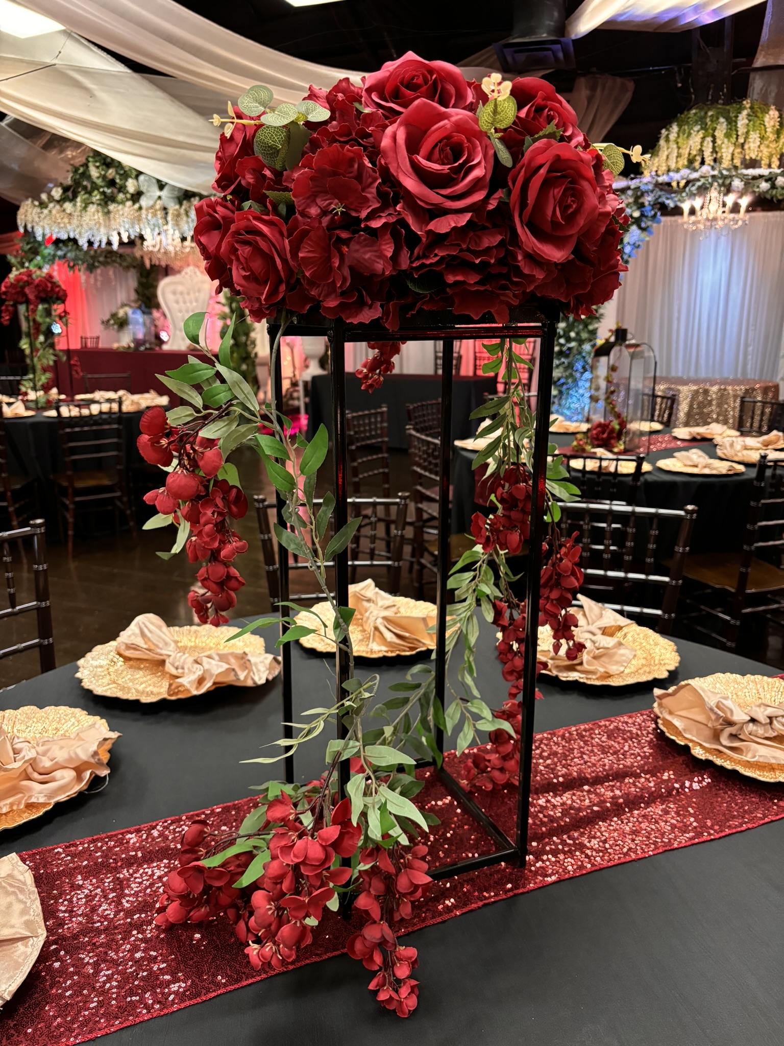 Black tower centerpiece with soft lighting and greenery for wedding or event tables at The Chateau at Forest Park