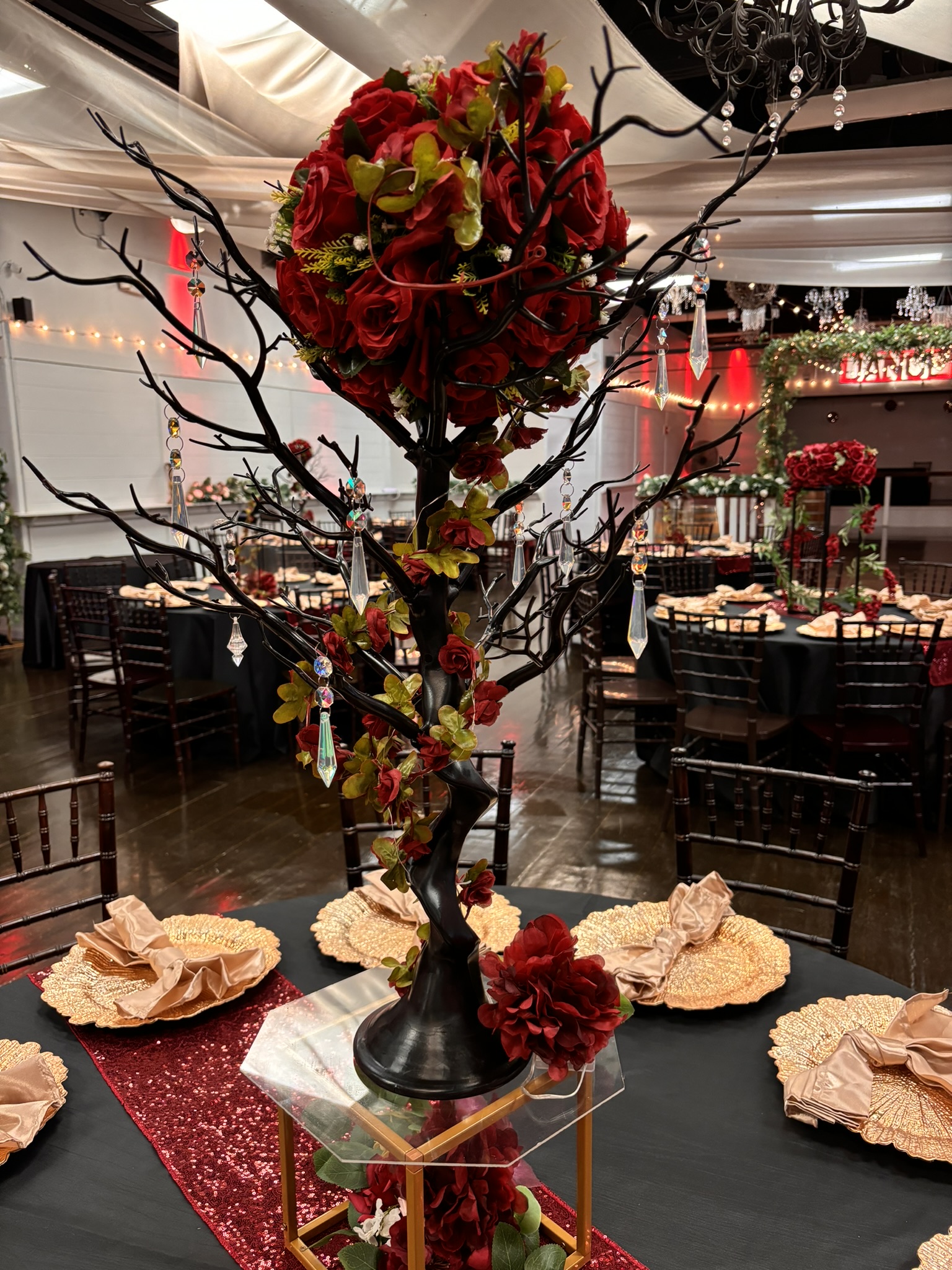 Rustic branch centerpiece with natural wood elements, flower ball, and greenery at The Chateau at Forest Park