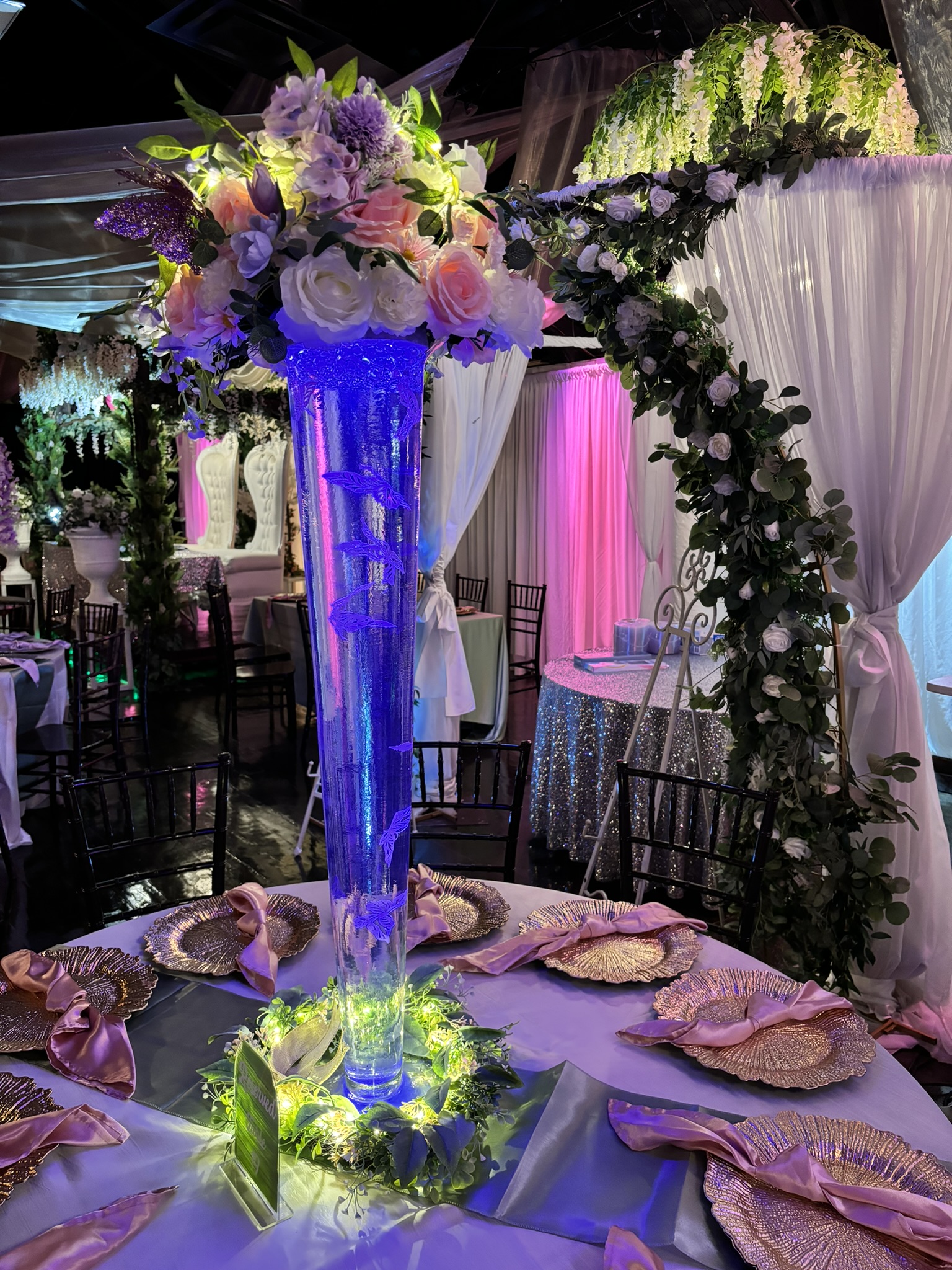 Modern glass trumpet vase centerpiece with florals and lighting accents for an elegant event table at The Chateau at Forest Park