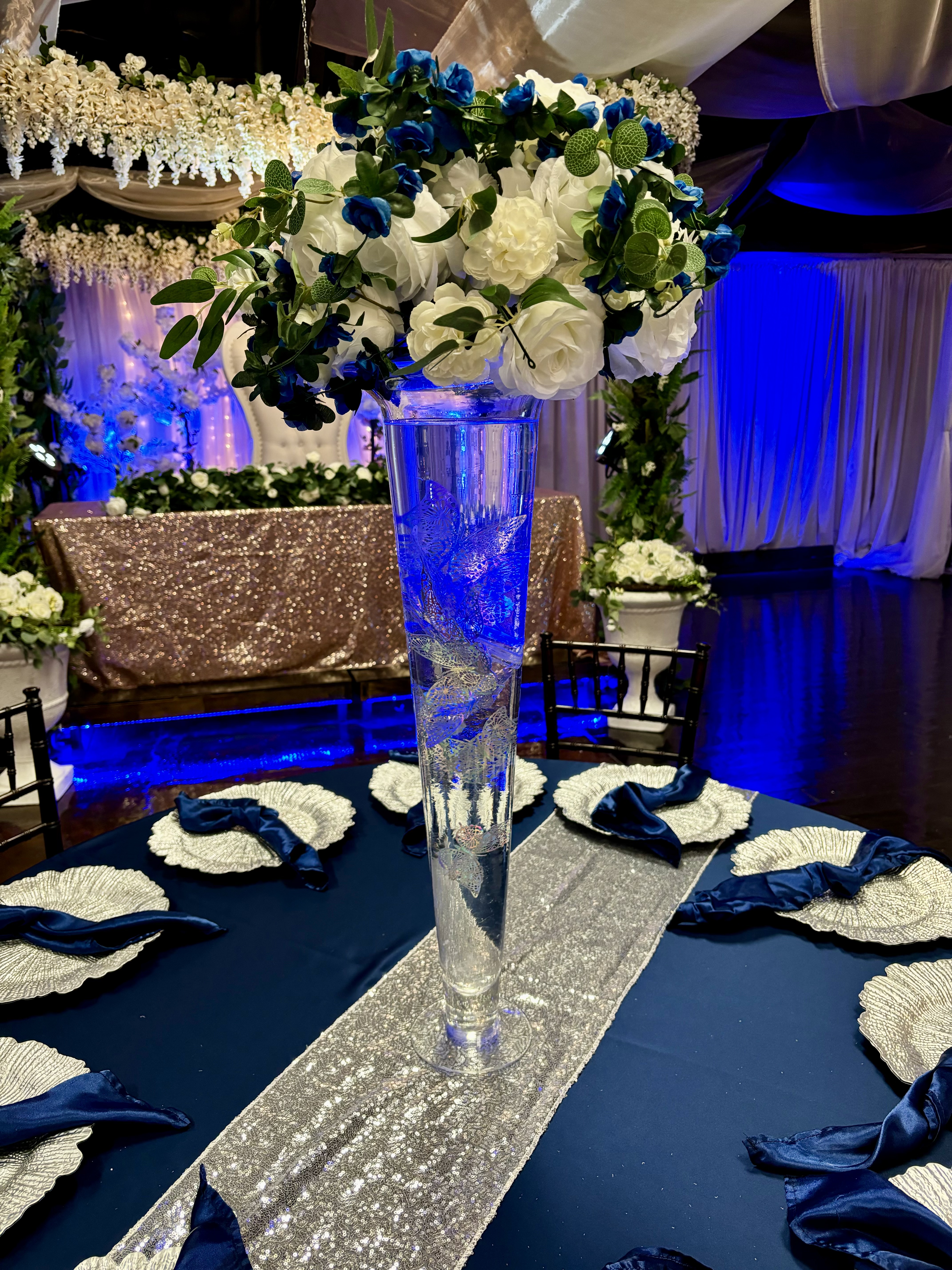 Modern glass trumpet vase centerpiece with gel beads, lights and more at the Chateau event venue