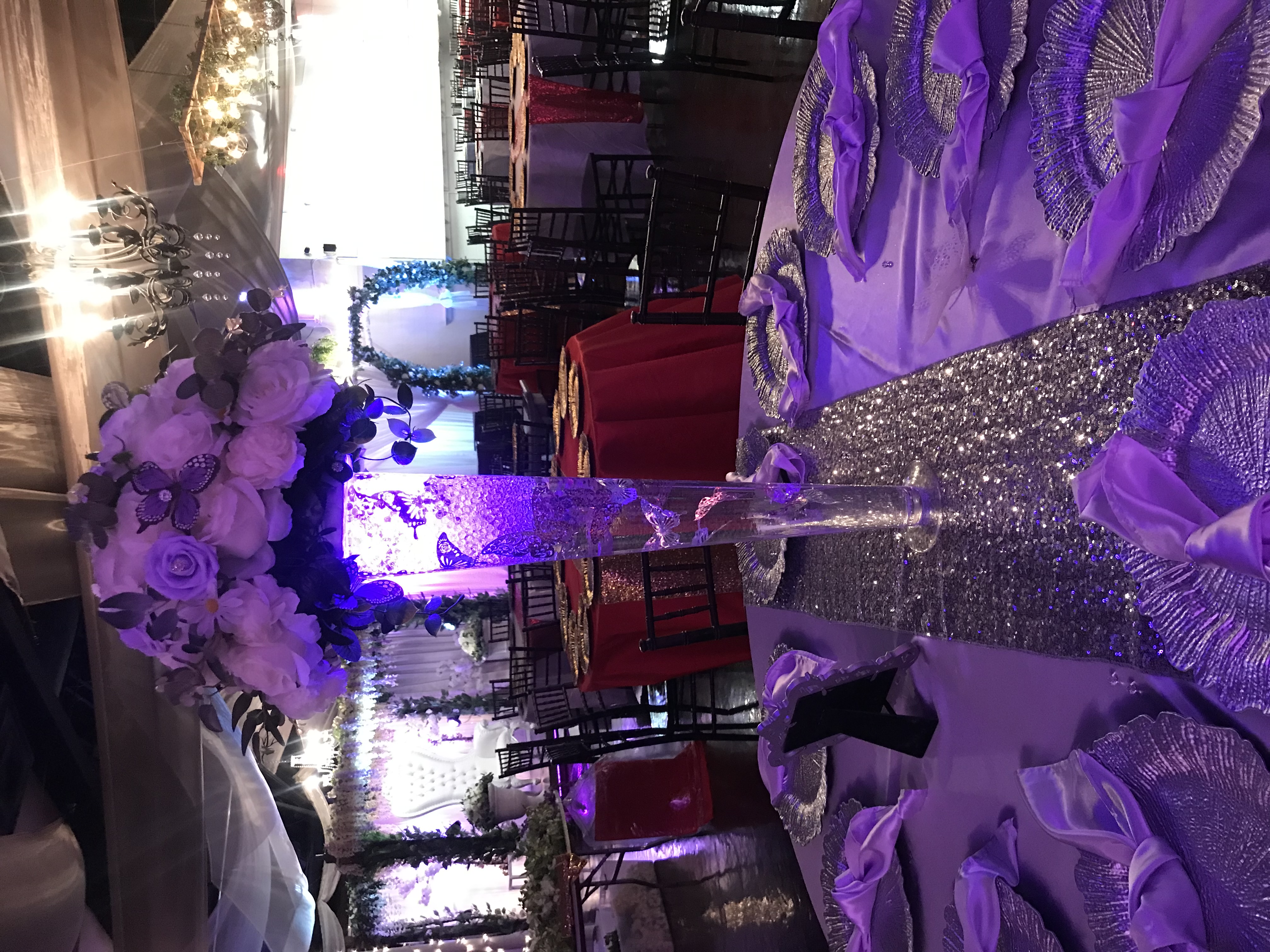 Glass trumpet vase centerpiece with twinkle lights, flowers, and greenery at the Chateau event venue