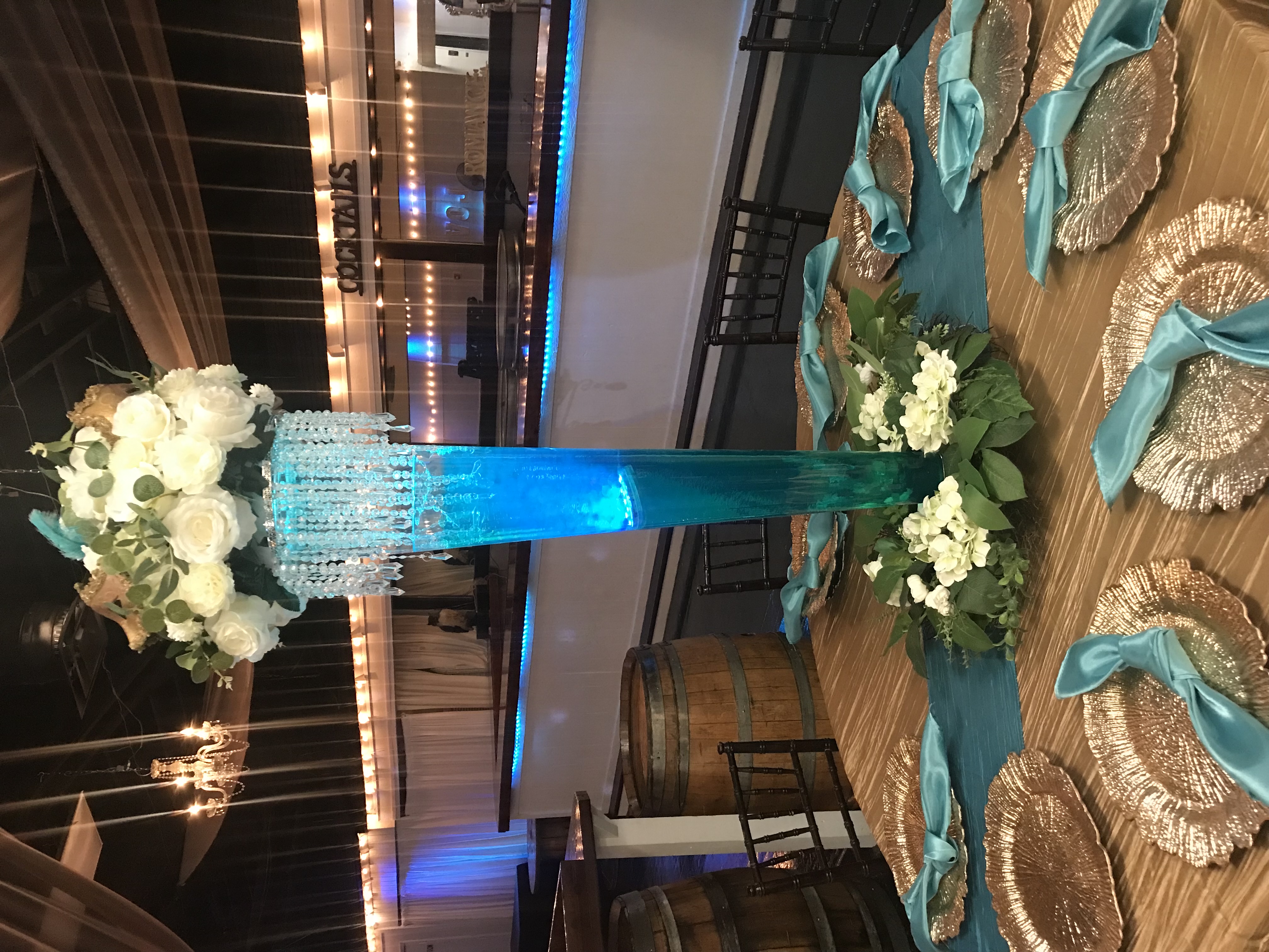 Modern glass pilsner vase centerpiece with flowers, greenery and more at the Chateau event venue