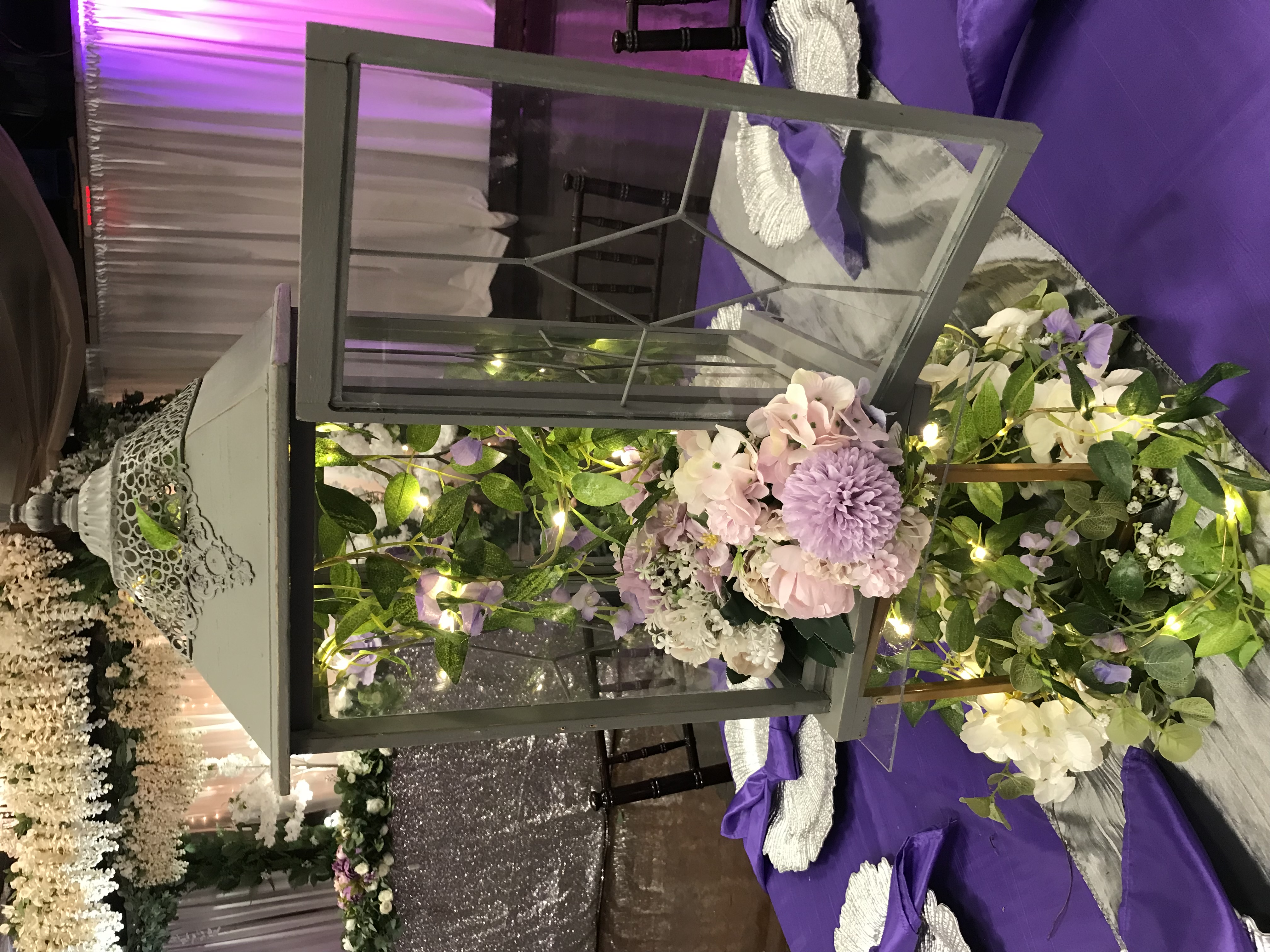 Rustic lantern centerpiece with twinkle lights, flowers, greenery and more at the Chateau event venue