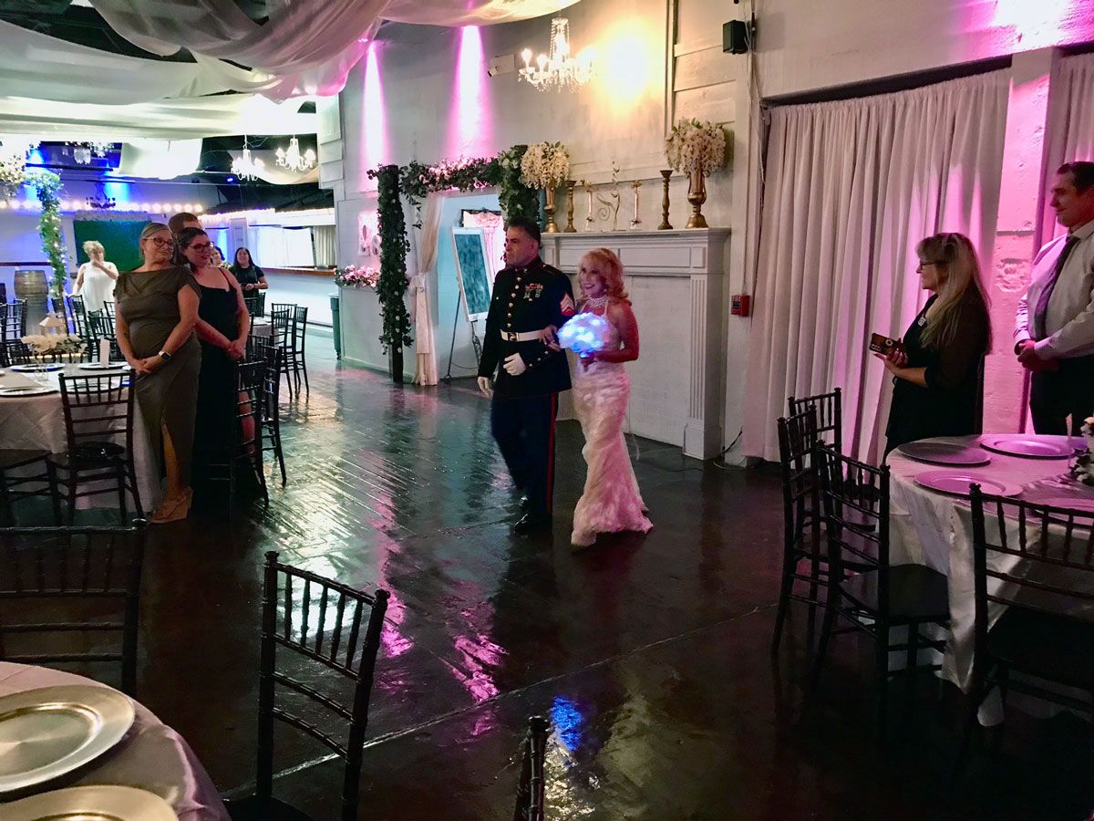 The Best Man walking the bride to the garden gazebo ceremony stage