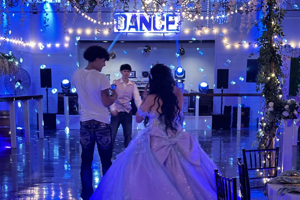 Quinceanera girl enters the dance floor inside the decorated ballroom at The Chateau at Forest Park