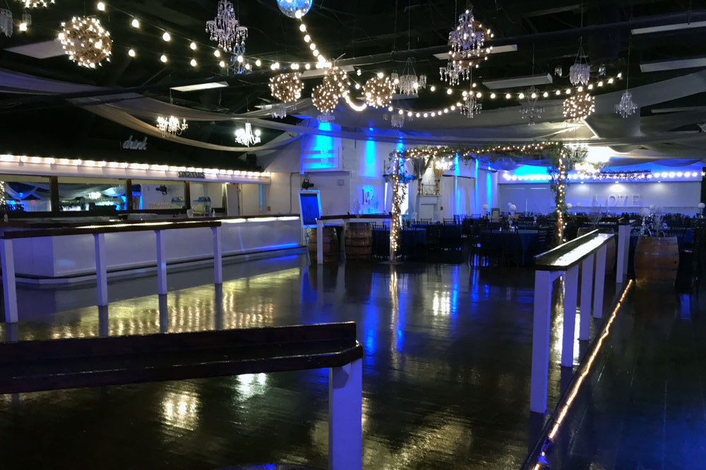 Shiny oak dance floor illuminated with party lights and ready for celebration
