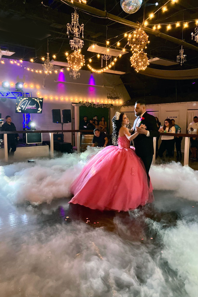 Father and daughter dancing on a softly lit ballroom dance floor during a special event
