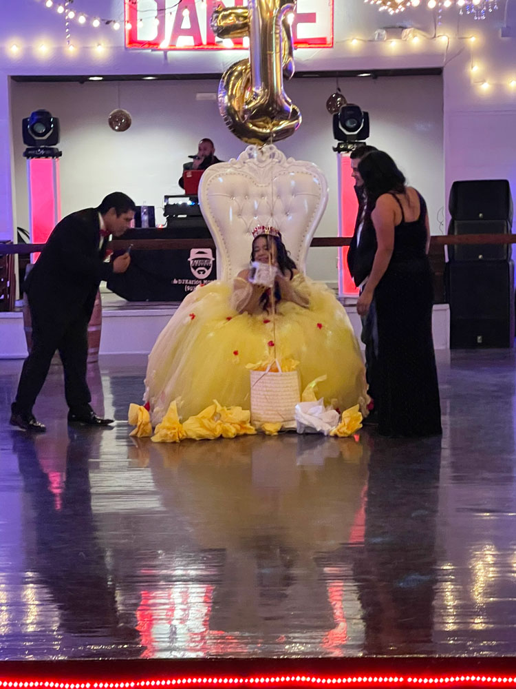 Classic ballroom dance floor beneath glowing chandeliers in a fairytale-inspired venue