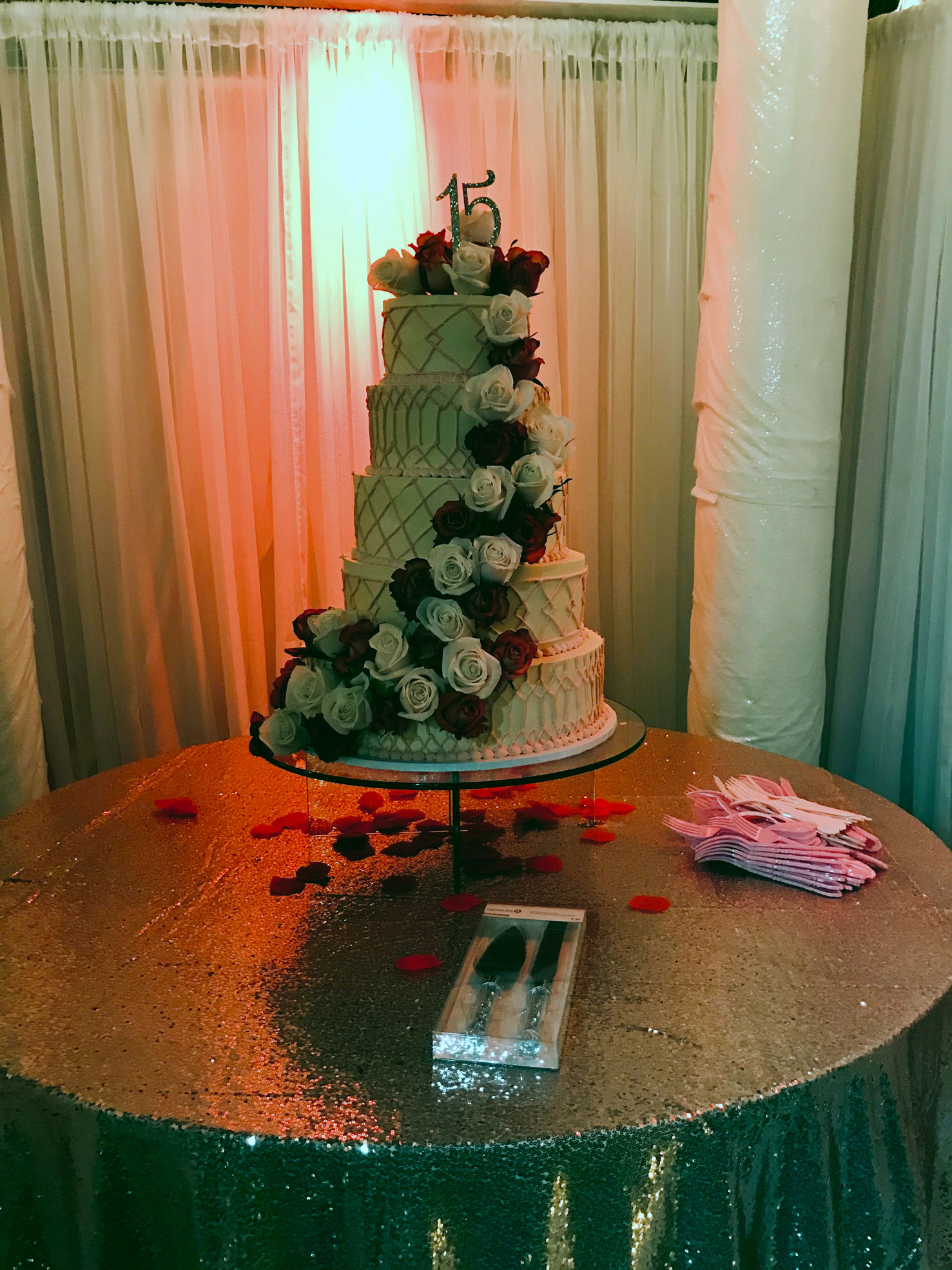 Elegant gold-accented table centerpiece with candlelight and red roses