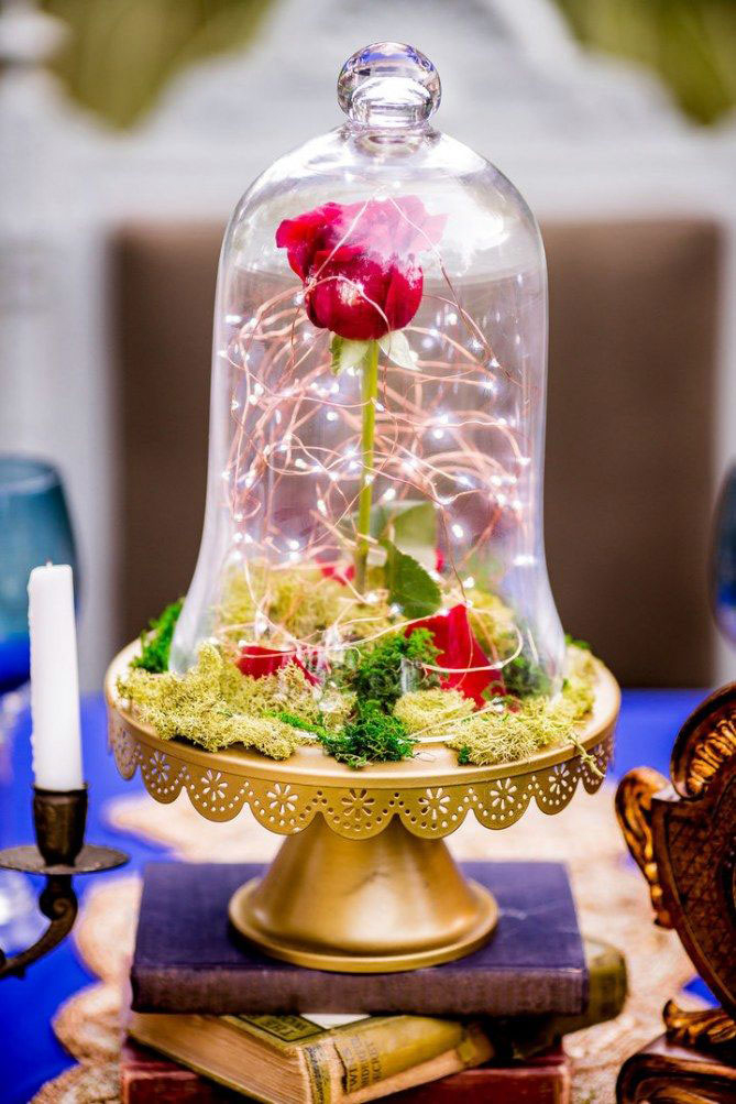 Fairytale-inspired centerpiece featuring twinkle lights and romantic floral design