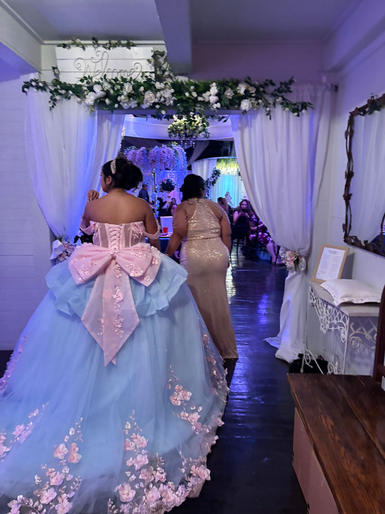 Celebration entry moment highlighted by elegant blue decor and warm lighting