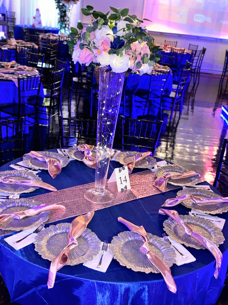 Table centerpiece featuring blue florals and elegant glass accents