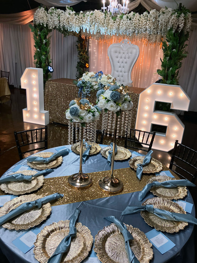 Reception centerpiece designed with layered blue hues and soft candlelight