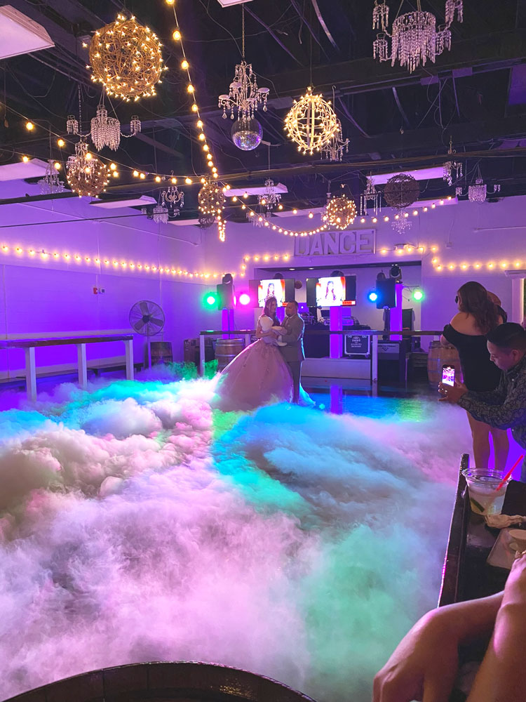 Cinderella-inspired quinceañera dance floor with chandeliers, elegant lighting, and fairytale decor