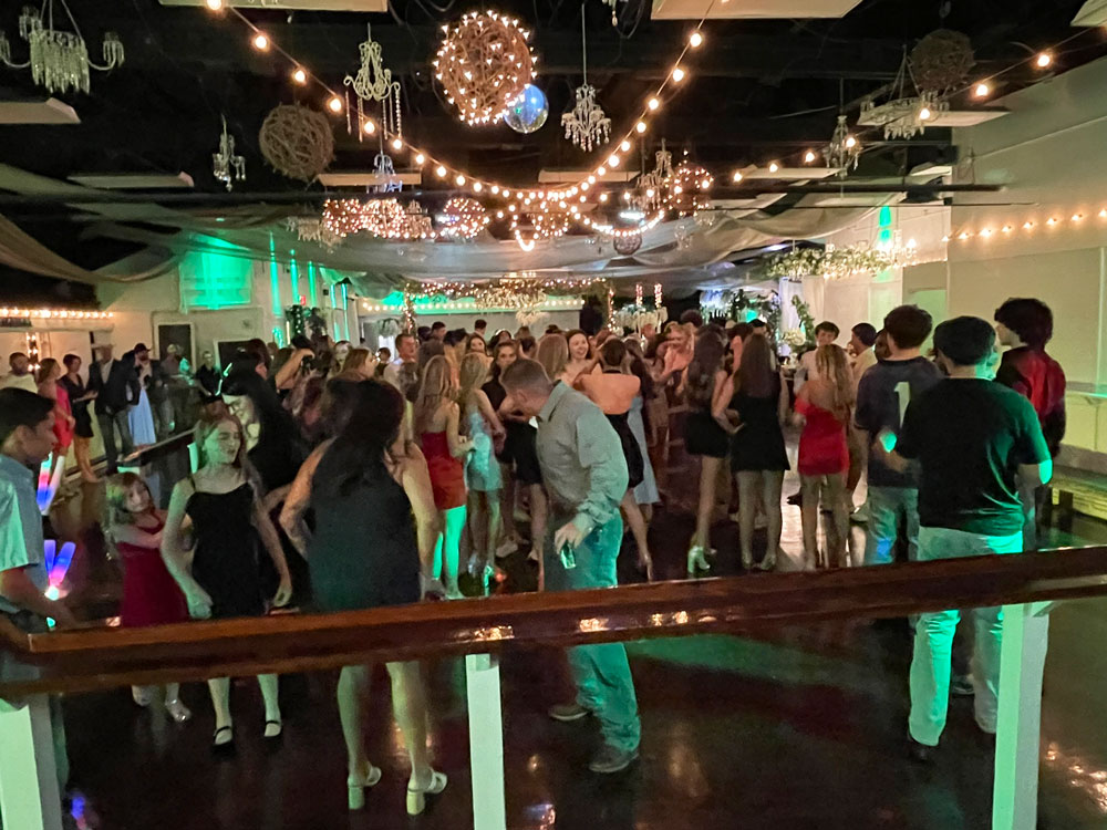 High energy dance floor surrounded by soft green lighting