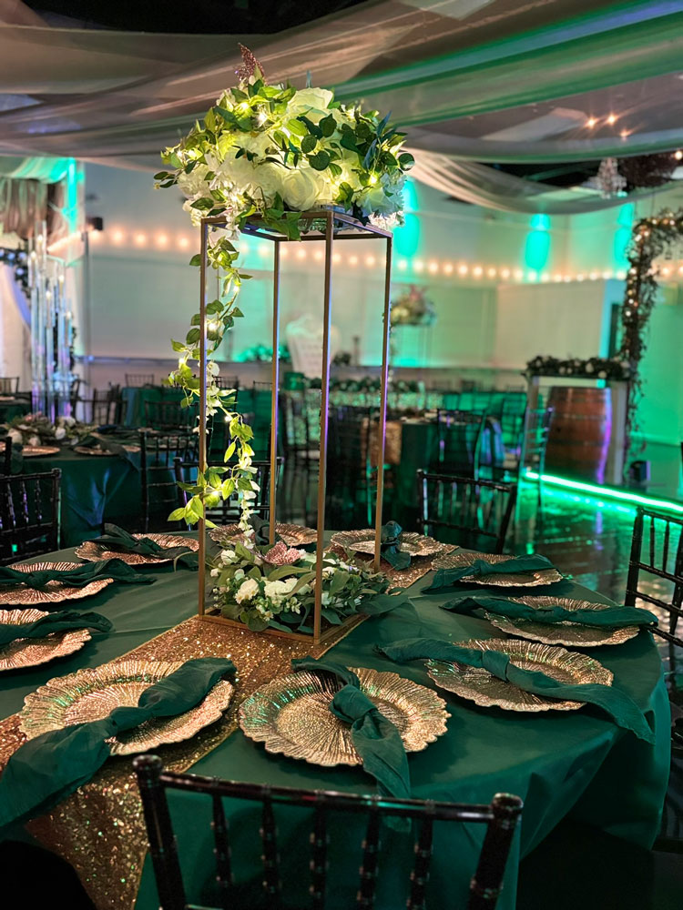 BEautiful tall table centerpiece with natural greenery and candle accents