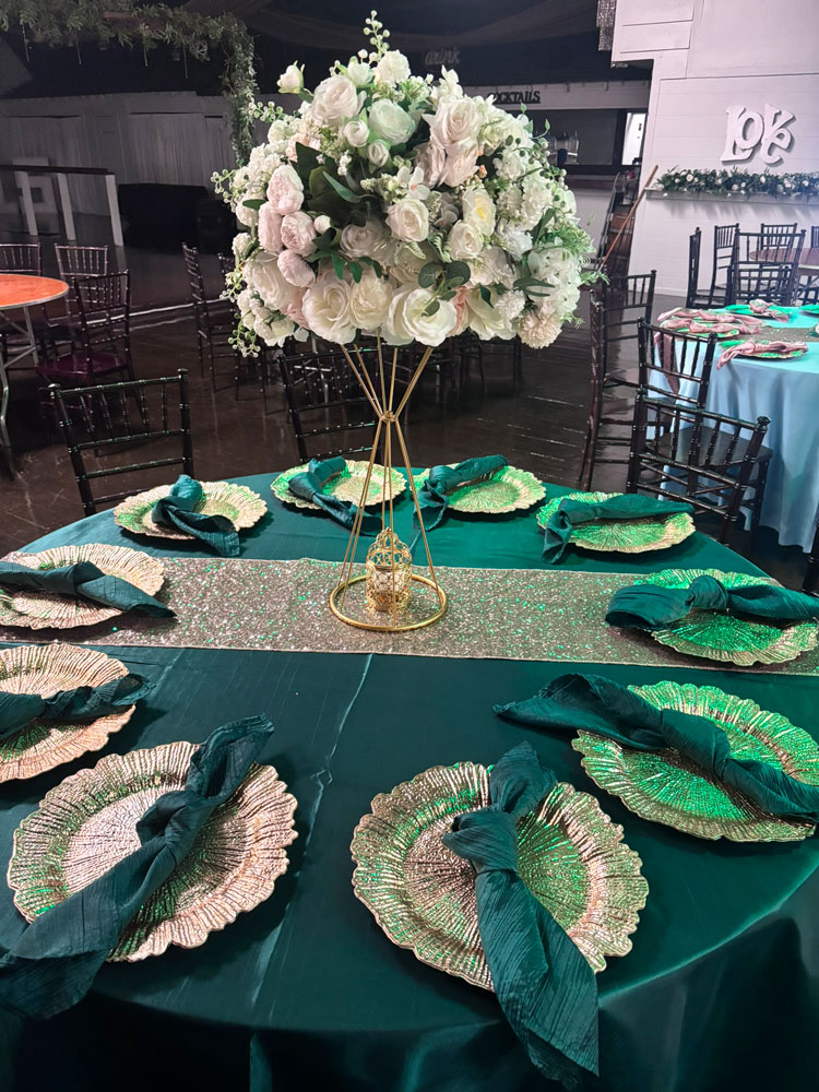 Wedding table centerpiece with natural greenery and candle accents