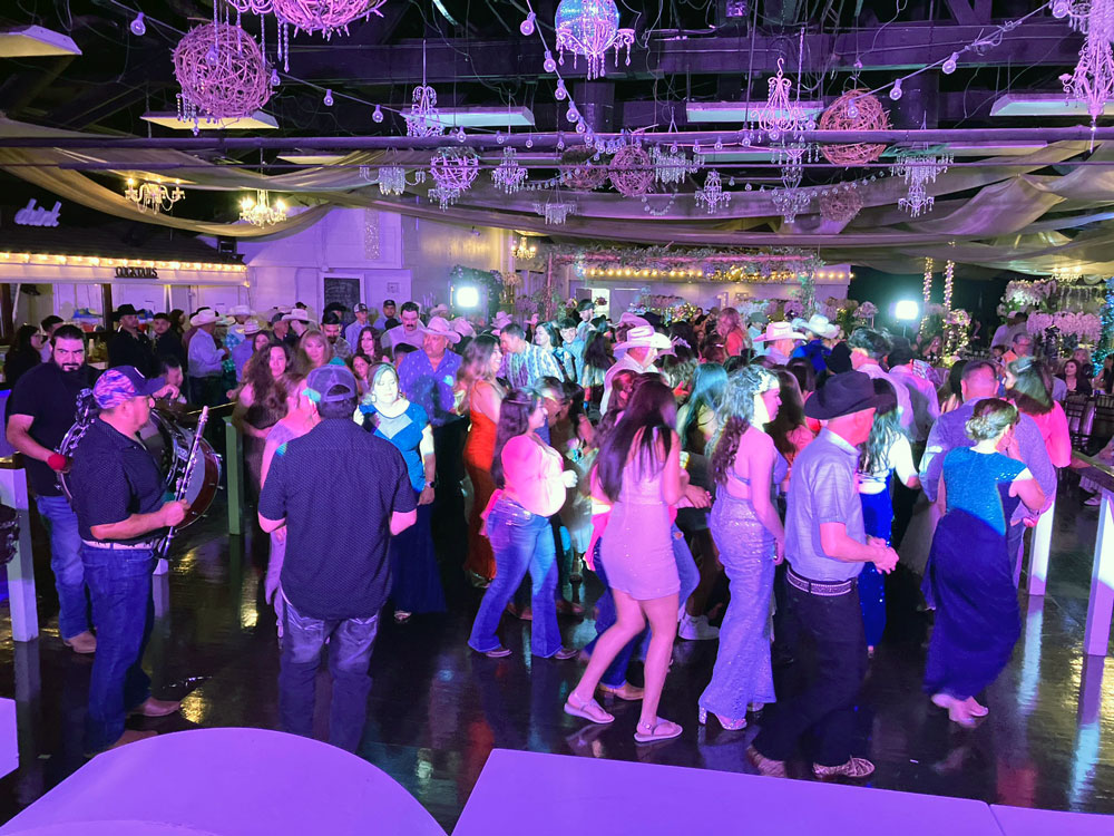 Dancing on a dance floor that's illuminated with high energy purple lighting