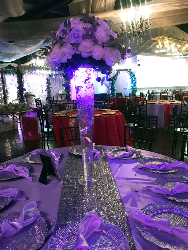 Purple and violet centerpiece arranged for a refined ballroom reception