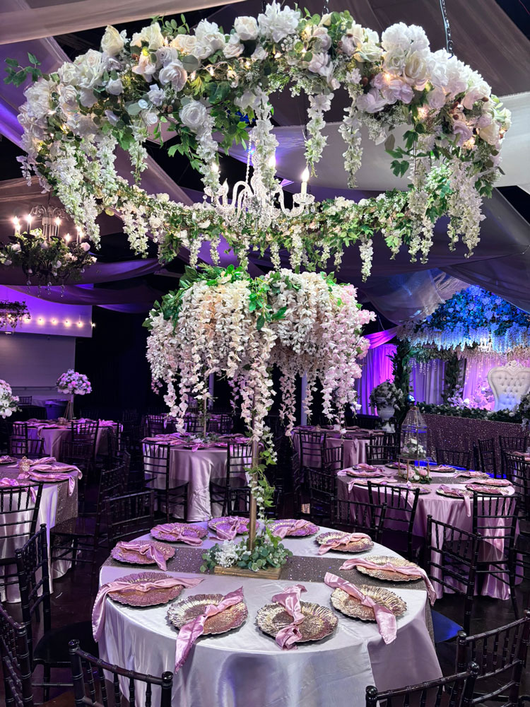 Plum and floral centerpiece arranged for a refined ballroom reception